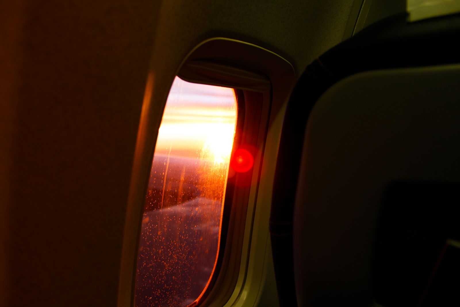 Warm sunset glowing through an airplane window